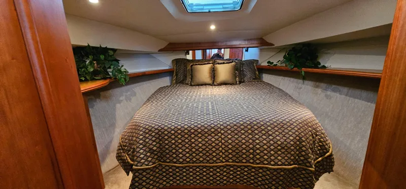 Slide: The Image of Luxurious bedroom interior of 2003 Silverton 42 Convertible yacht with elegant bedding and skylight. - 39