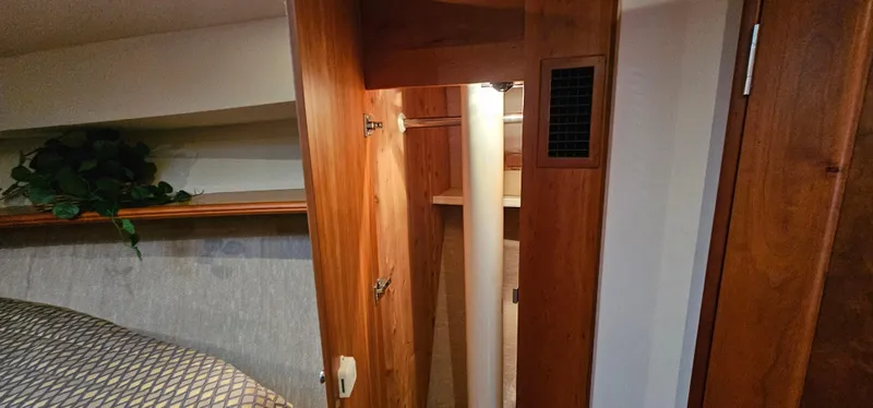 Slide: The Image of Interior of 2003 Silverton 42 Convertible yacht with wooden cabinetry and cozy decor. - 40