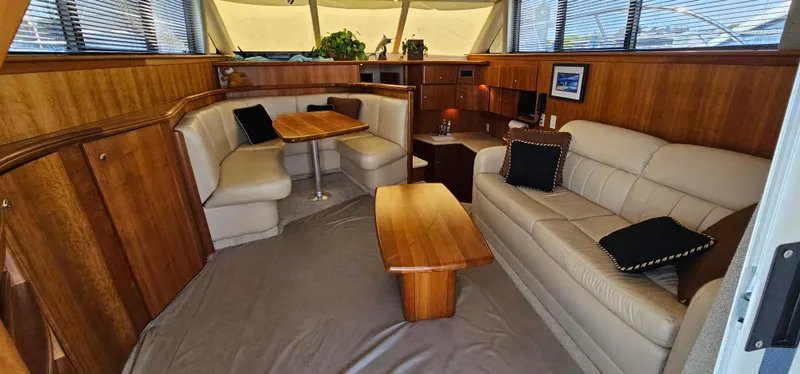 Slide: The Image of Luxurious interior of 2003 Silverton 42 Convertible yacht with elegant seating and wooden accents. - 47