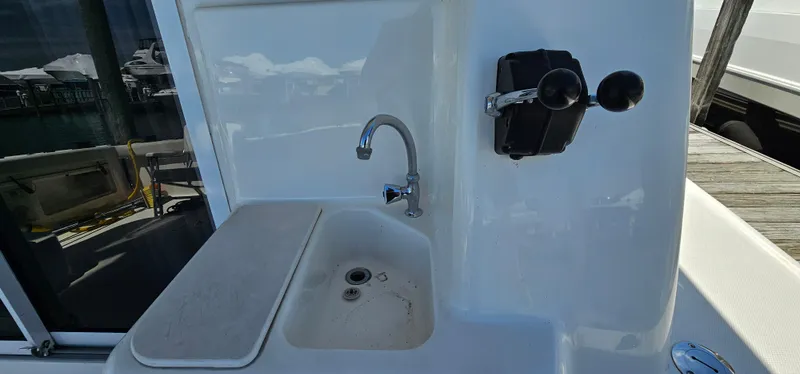 Slide: The Image of 2003 Silverton 42 Convertible yacht sink and control panel on deck. - 49