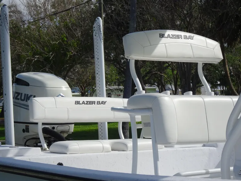Slide: The Image of 2019 Blazer Bay 2400 boat with Suzuki engine, featuring white seating and sleek design. - 11