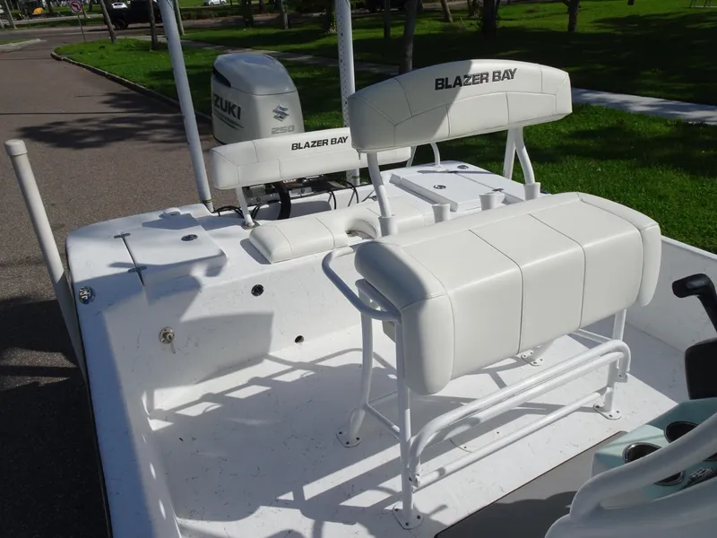 Slide: The Image of 2019 Blazer Bay 2400 boat with Suzuki outboard motor, white seating, and spacious deck. - 12