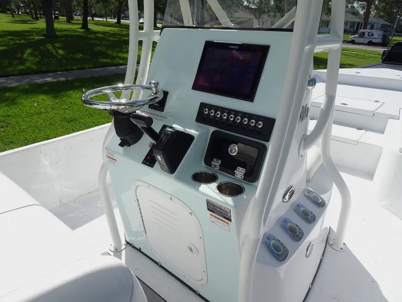 Slide: The Image of 2019 Blazer Bay 2400 boat console with steering wheel and electronic controls. - 14