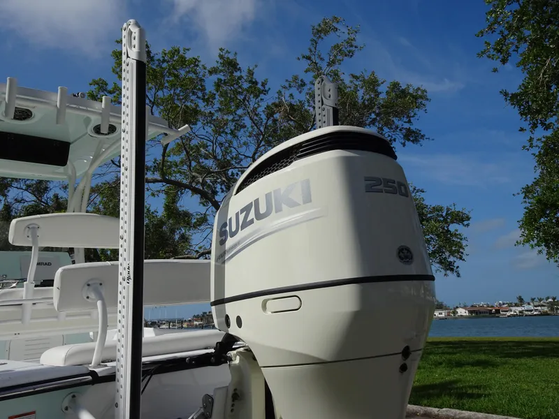 Slide: The Image of 2019 Blazer Bay 2400 boat with Suzuki 250 outboard motor, parked near a lake. - 25