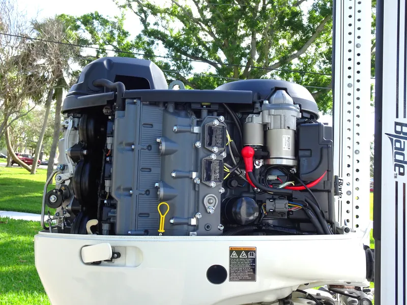Slide: The Image of 2019 Blazer Bay 2400 engine, detailed view, outdoors with trees in background. - 26