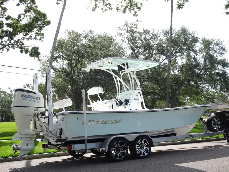 Slide: The Image of 2019 Blazer Bay 2400 boat on trailer with Suzuki outboard motor. - 4