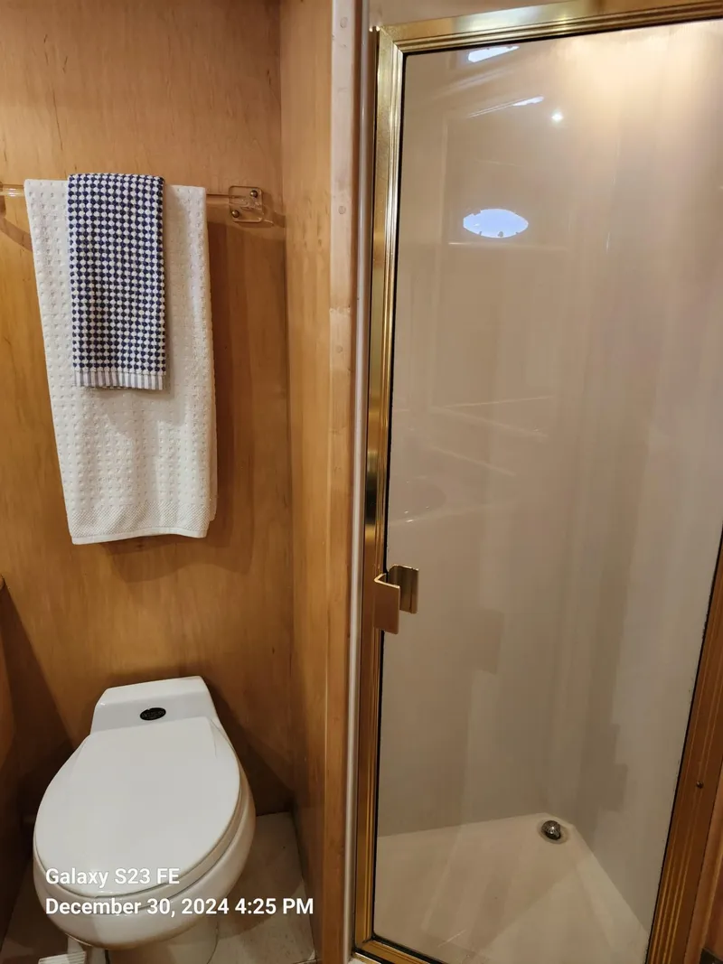 Slide: The Image of Cozy bedroom in 1999 Navigator 4800 CLASSIC yacht with skylight and wooden accents. - 18