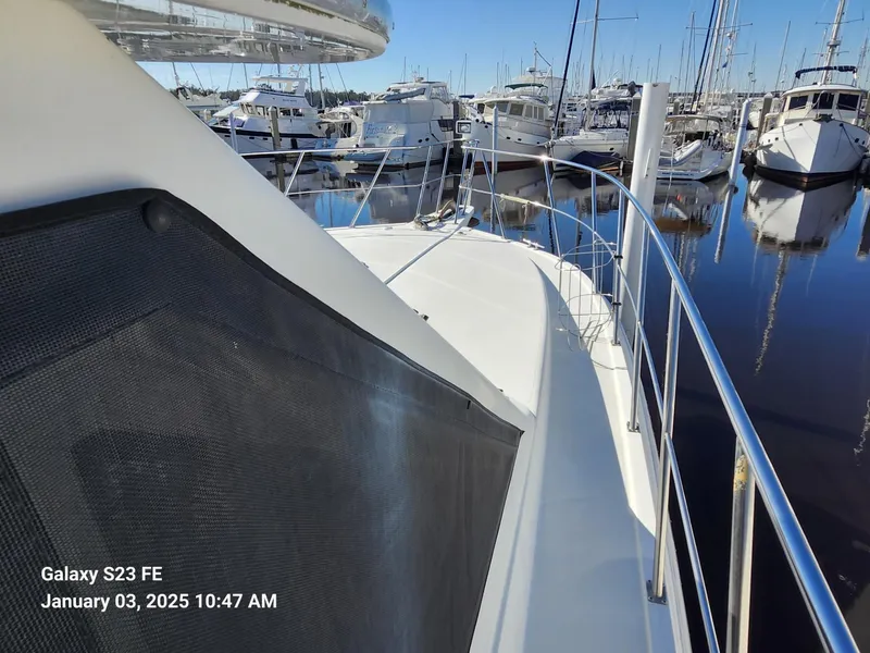 Slide: The Image of Spacious deck of 1999 Navigator 4800 CLASSIC yacht, featuring clean, white flooring. - 28