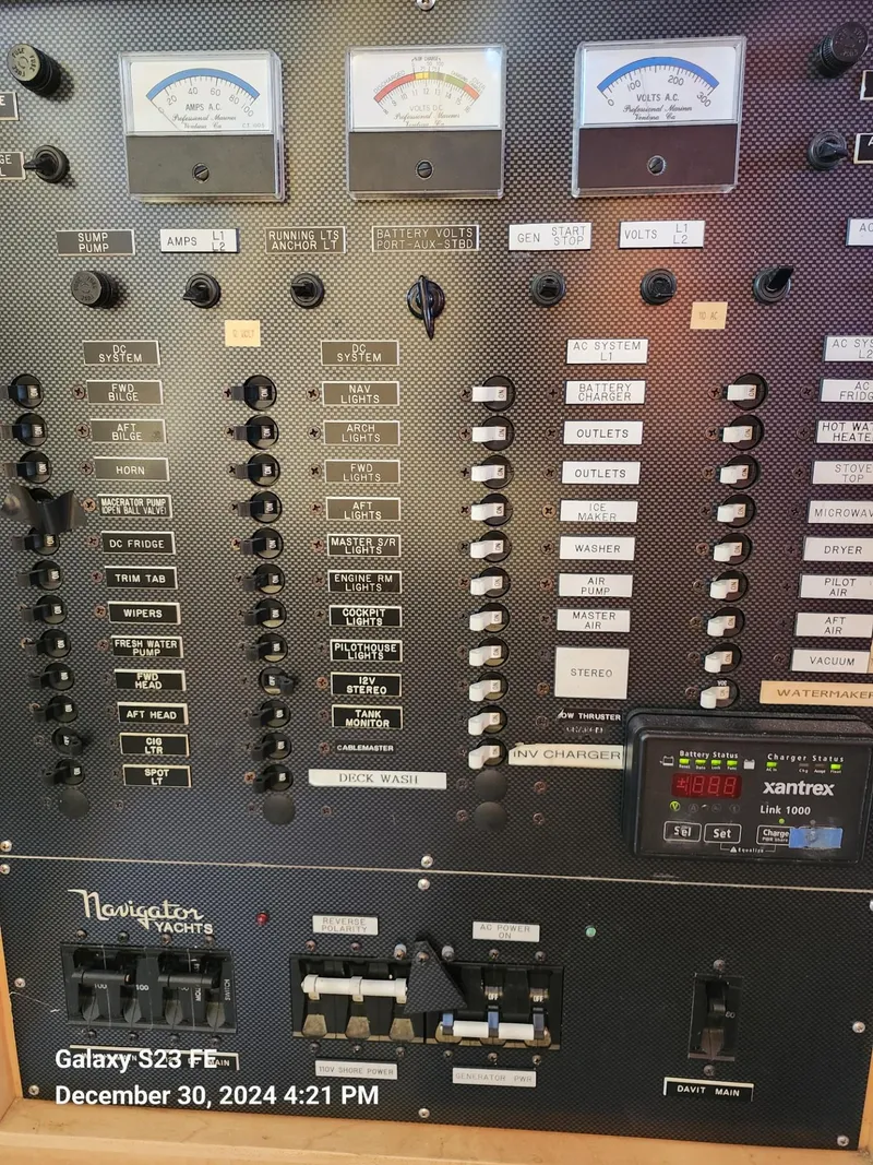 Slide: The Image of A 1999 Navigator 4800 CLASSIC yacht docked at a marina with a scenic waterfront view. - 40