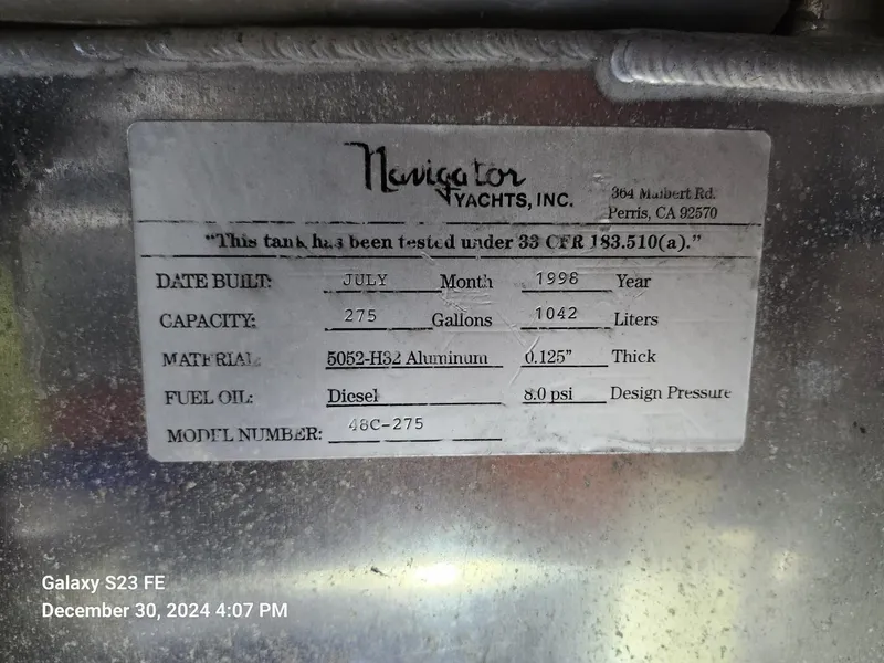 Slide: The Image of Engine room of 1999 Navigator 4800 CLASSIC yacht, showcasing detailed machinery and components. - 44