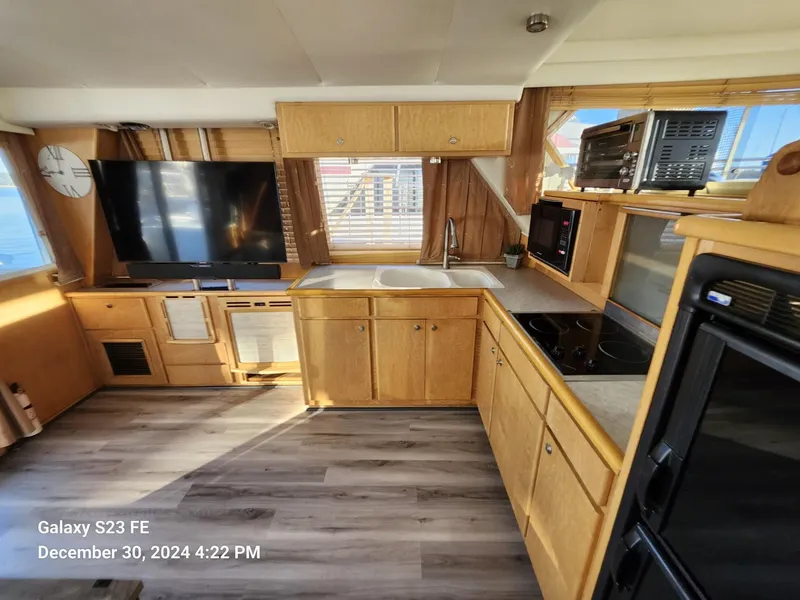 Slide: The Image of Interior of 1999 Navigator 4800 CLASSIC yacht kitchen with appliances and wooden cabinetry. - 7