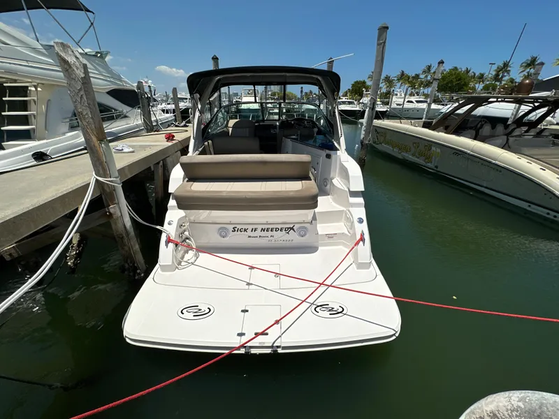 Slide: The Image of 2015 Regal 32 Express boat docked at marina, rear view with seating area. - 1