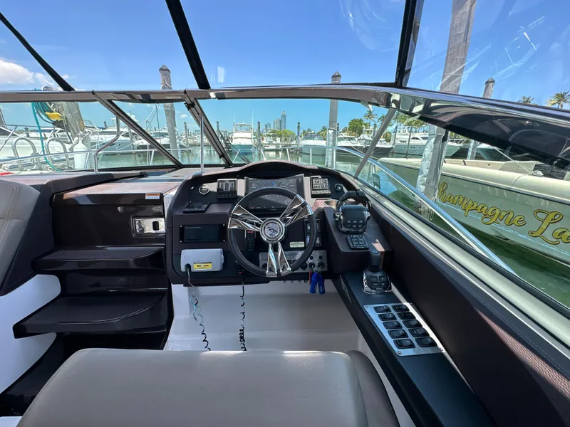 Slide: The Image of Cockpit view of 2015 Regal 32 Express boat with marina background. - 10