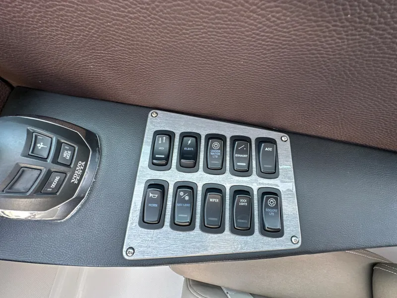 Slide: The Image of Control panel of a 2015 Regal 32 Express boat with various switches and buttons. - 13