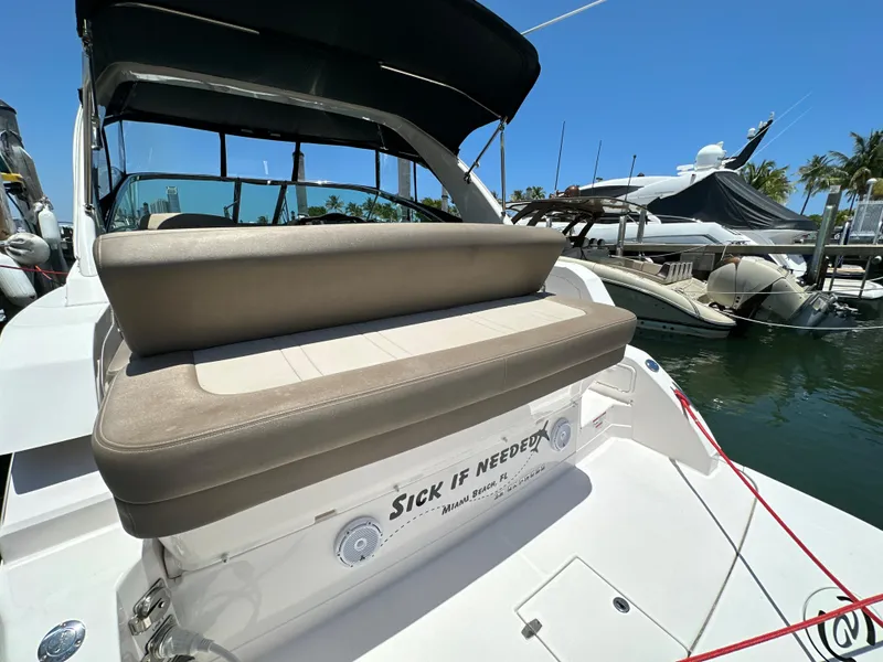 Slide: The Image of 2015 Regal 32 Express boat docked, featuring comfortable seating and sleek design. - 2