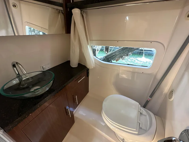 Slide: The Image of Bathroom interior of 2015 Regal 32 Express boat with sink and toilet. - 23