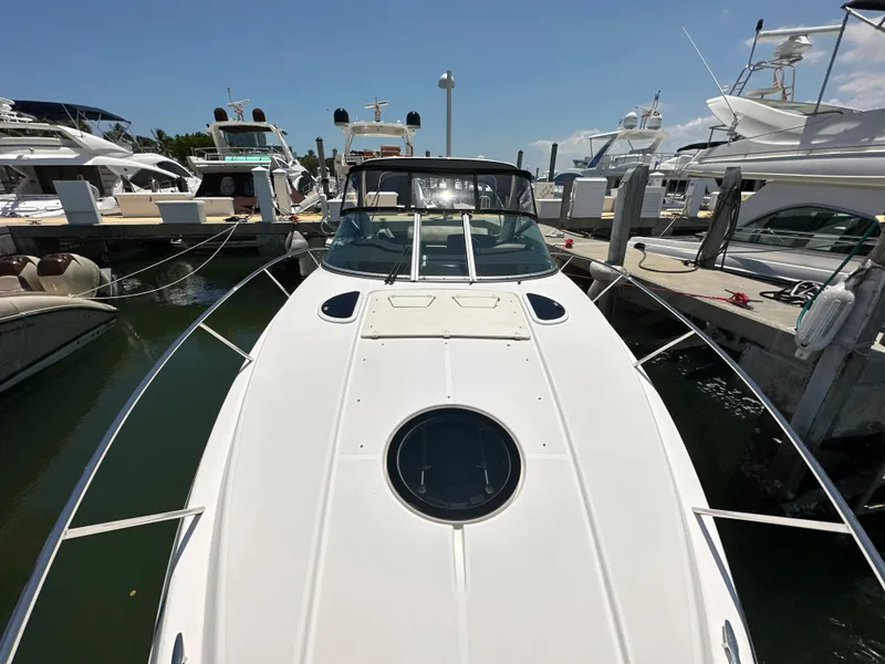 Slide: The Image of 2015 Regal 32 Express boat docked at marina, surrounded by other vessels. - 24