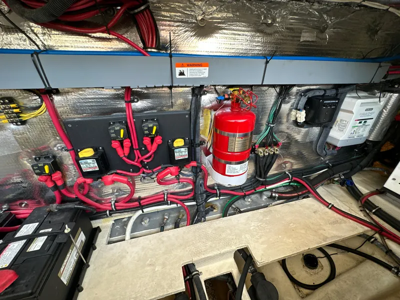 Slide: The Image of Engine compartment of a 2015 Regal 32 Express boat, featuring wiring and a fire extinguisher. - 29
