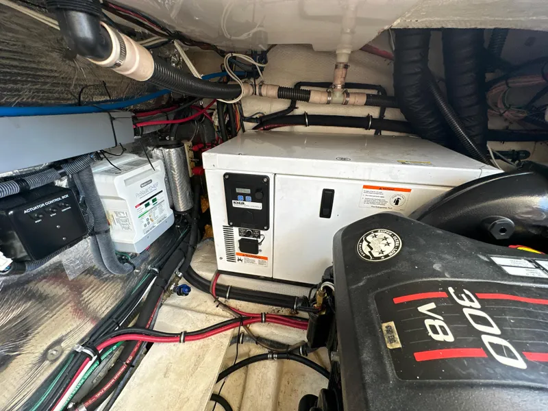 Slide: The Image of Engine compartment of 2015 Regal 32 Express boat with generator and wiring. - 30