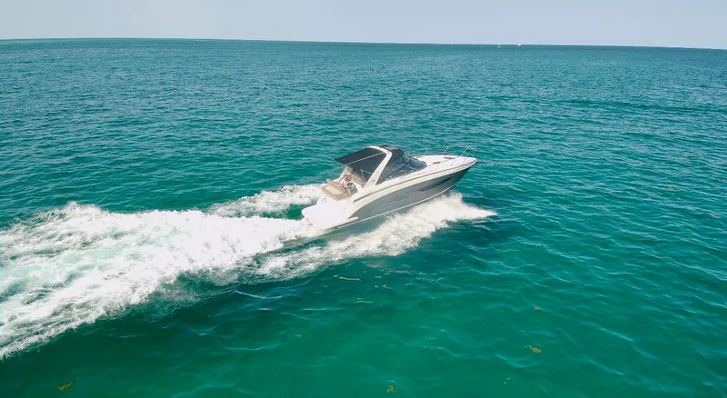 Slide: The Image of 2015 Regal 32 Express cruising on open blue ocean waters. - 36