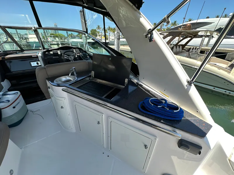 Slide: The Image of 2015 Regal 32 Express yacht interior with kitchenette and sink. - 6