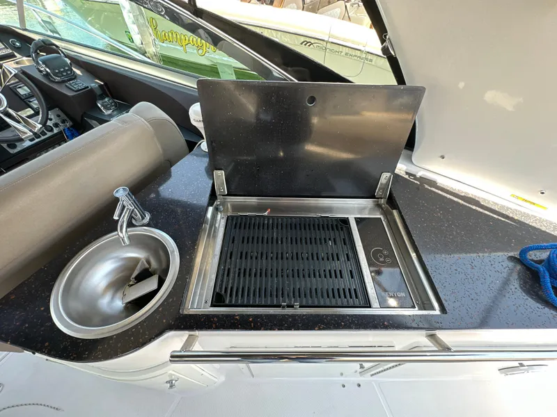 Slide: The Image of Outdoor kitchen on 2015 Regal 32 Express boat with sink and grill. - 7