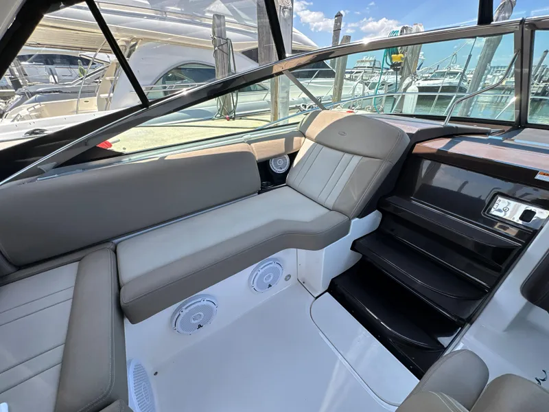 Slide: The Image of 2015 Regal 32 Express boat interior with seating and stairs, showcasing luxury design. - 9