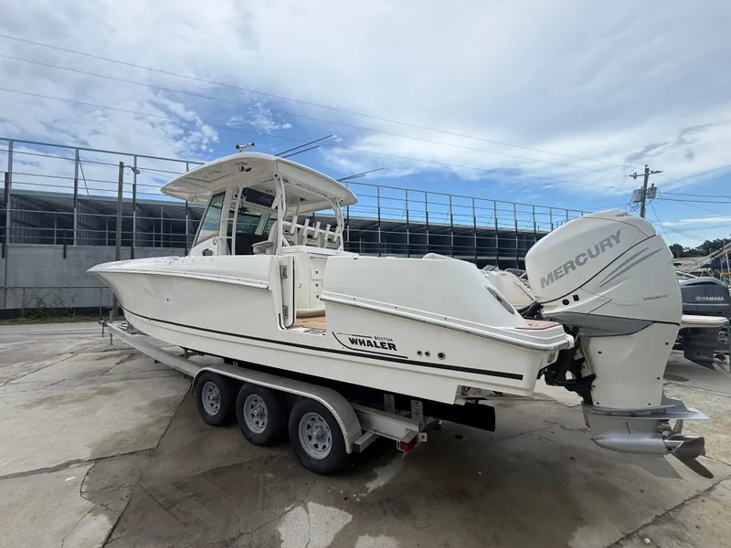 Slide: The Image of 2017 Boston Whaler 350 Outrage boat with Mercury engines on a trailer. - 11