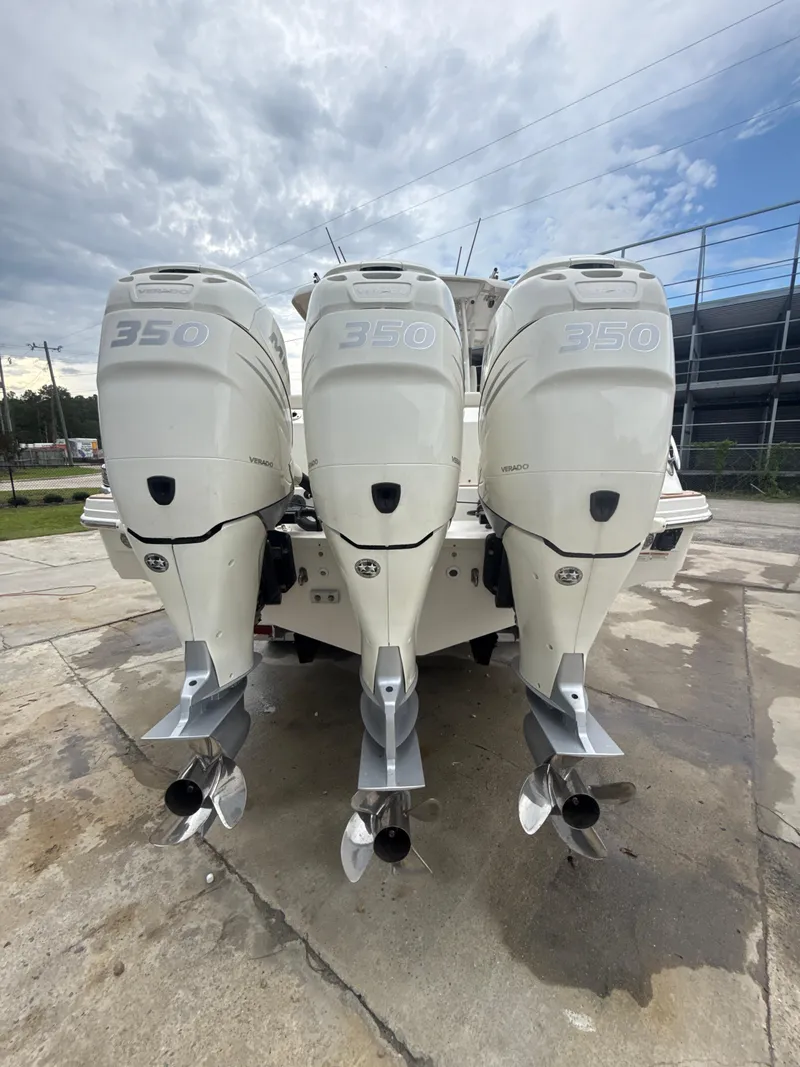 Slide: The Image of 2017 Boston Whaler 350 Outrage with triple outboard engines, rear view. - 13