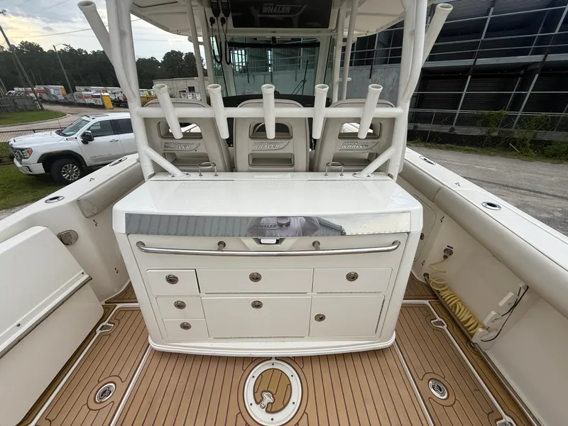 Slide: The Image of 2017 Boston Whaler 350 Outrage boat interior with storage and rod holders. - 14