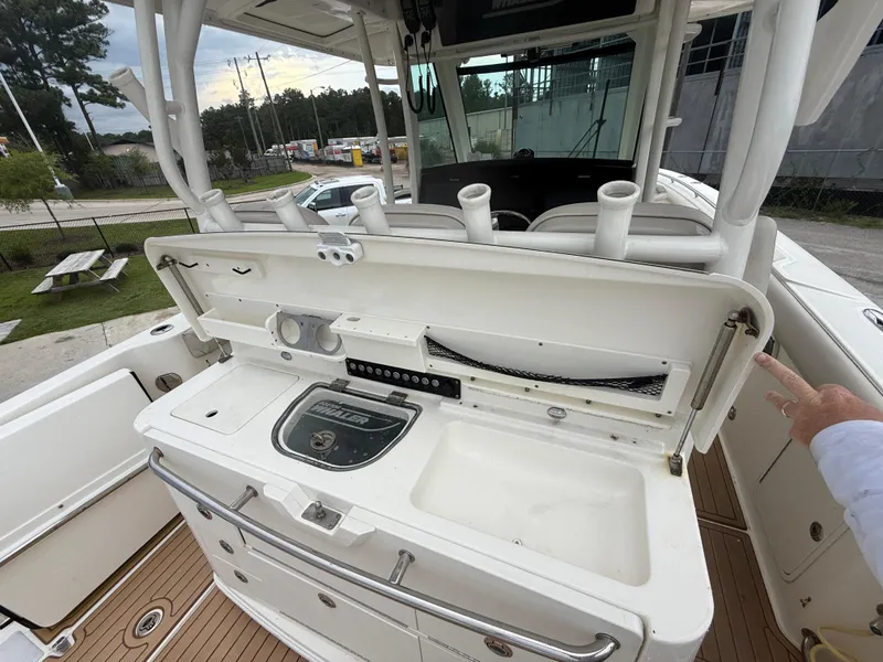 Slide: The Image of 2017 Boston Whaler 350 Outrage boat interior with fishing station and rod holders. - 17