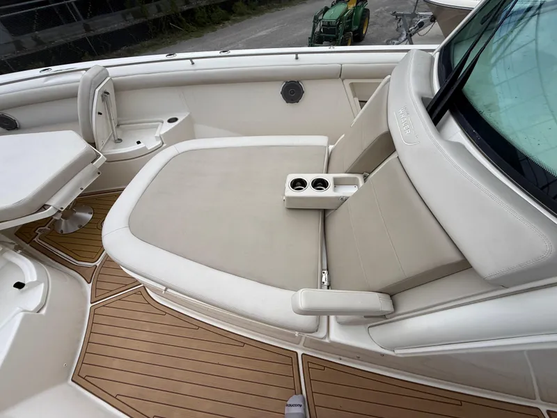 Slide: The Image of 2017 Boston Whaler 350 Outrage boat interior with cushioned seating and cup holders. - 22