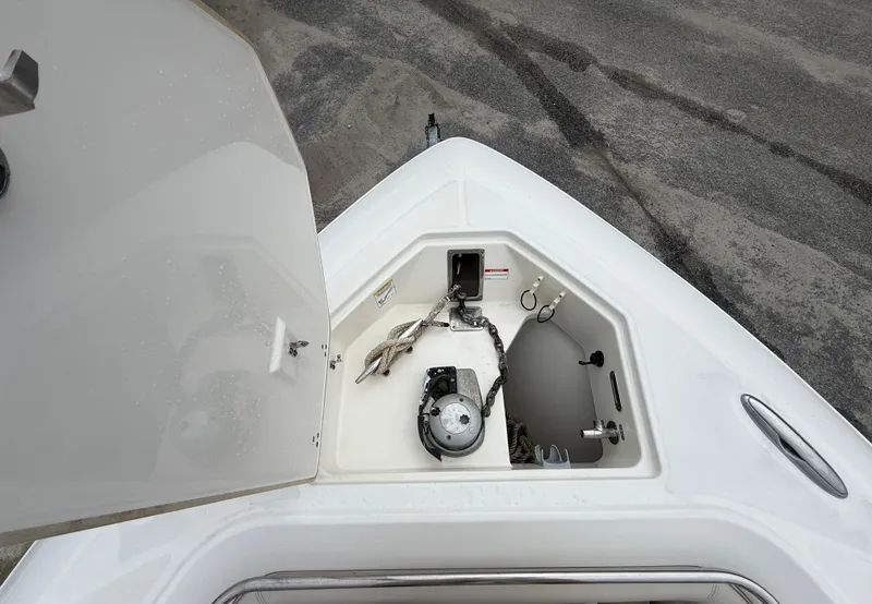 Slide: The Image of 2017 Boston Whaler 350 Outrage anchor storage compartment, open lid, showing anchor and equipment. - 25