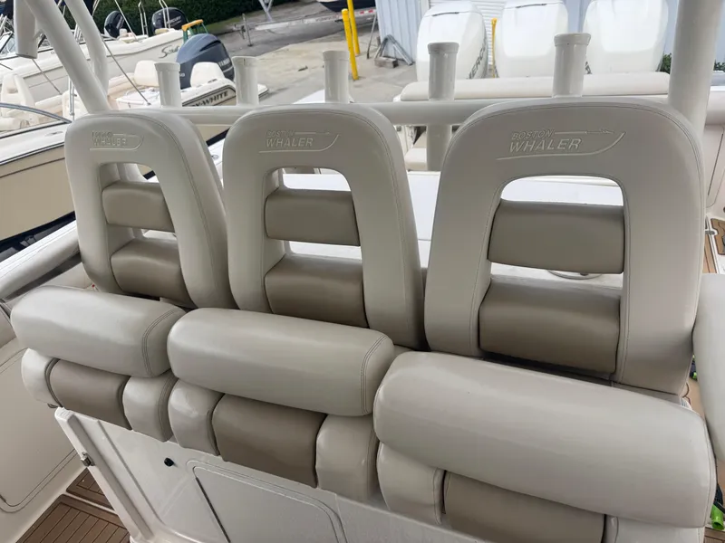 Slide: The Image of 2017 Boston Whaler 350 Outrage boat seats, beige leather, outdoor setting. - 26