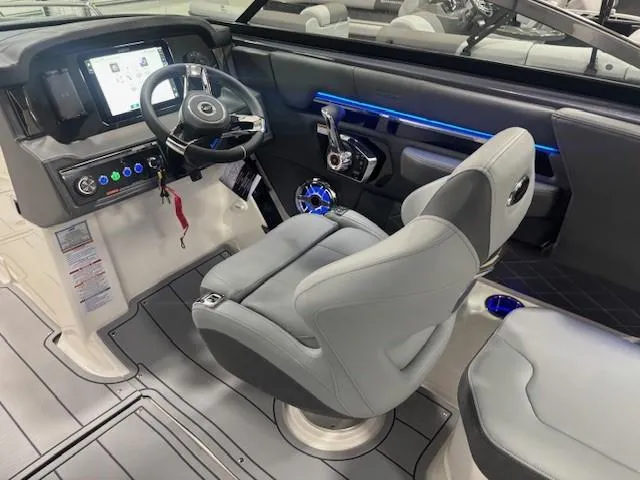 Slide: The Image of 2025 Chaparral 2870 boat interior with modern helm, steering wheel, and seating. - 10