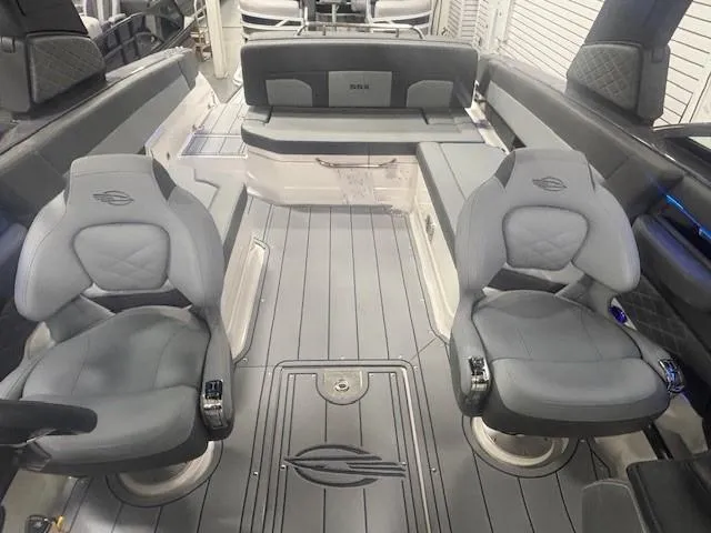Slide: The Image of 2025 Chaparral 2870 boat interior with gray seating and modern design. - 11