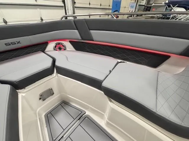 Slide: The Image of 2025 Chaparral 2870 SSX boat interior with gray seating and red accents. - 14