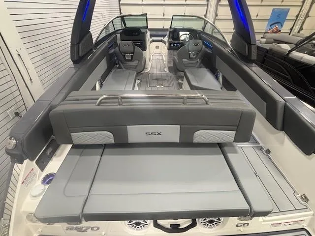Slide: The Image of 2025 Chaparral 2870 boat interior with gray seating and modern dashboard. - 19