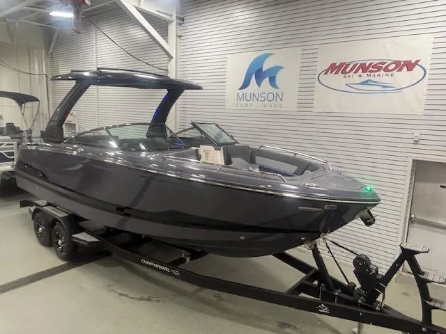 Slide: The Image of 2025 Chaparral 2870 boat on trailer in showroom, Munson Ski & Marine signage. - 2
