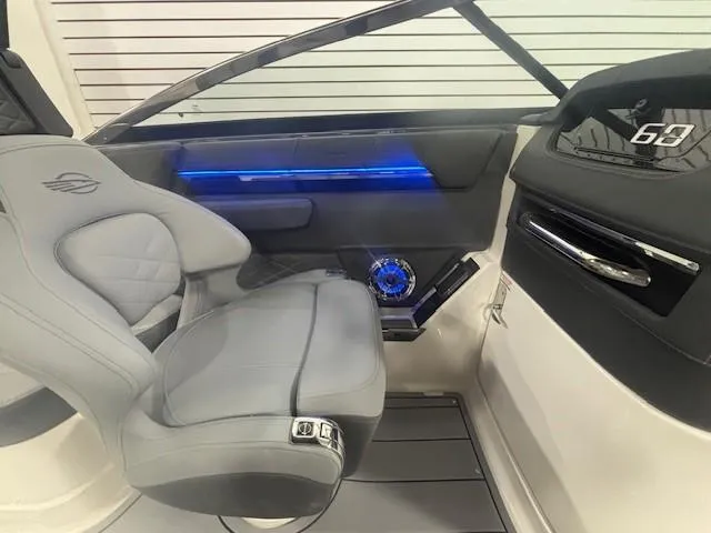 Slide: The Image of 2025 Chaparral 2870 boat interior with modern seating and illuminated dashboard. - 22