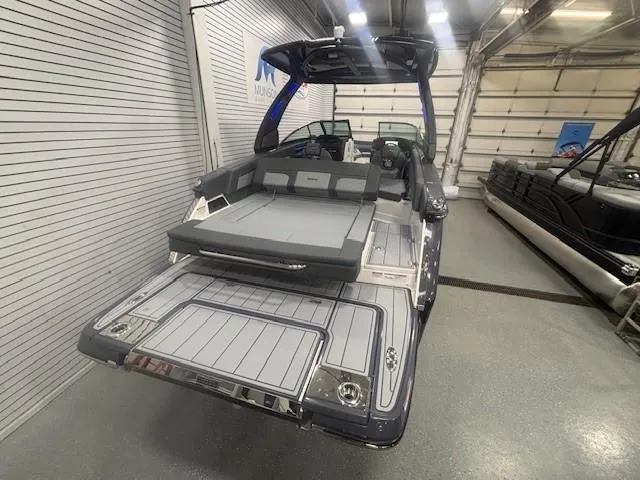 Slide: The Image of 2025 Chaparral 2870 boat in showroom, featuring sleek design and spacious seating. - 27