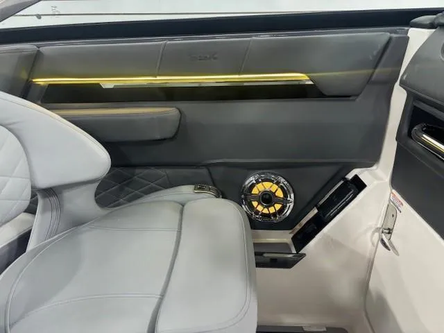 Slide: The Image of 2025 Chaparral 2870 interior with sleek design, featuring leather seating and modern speaker system. - 34