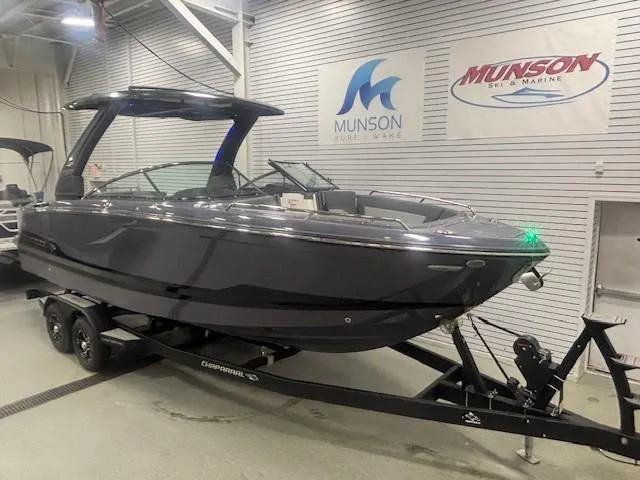 Slide: The Image of 2025 Chaparral 2870 boat on trailer in showroom, Munson Marine signage visible. - 4