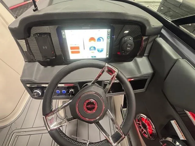 Slide: The Image of 2025 Chaparral 2870 boat dashboard with modern steering wheel and digital display. - 6