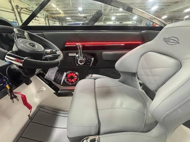 Slide: The Image of Interior of 2025 Chaparral 2870 boat with modern steering and luxurious seating. - 9