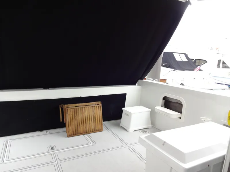 Slide: The Image of 1998 Navigator 53 Classic yacht interior with wooden table and seating area. - 10