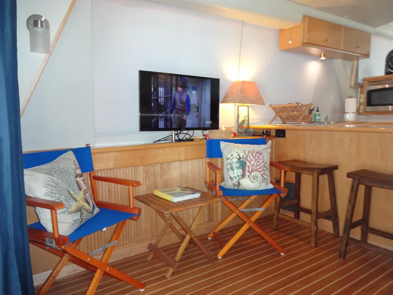 Slide: The Image of Cozy interior of 1998 Navigator 53 Classic yacht with chairs, TV, and kitchenette. - 14