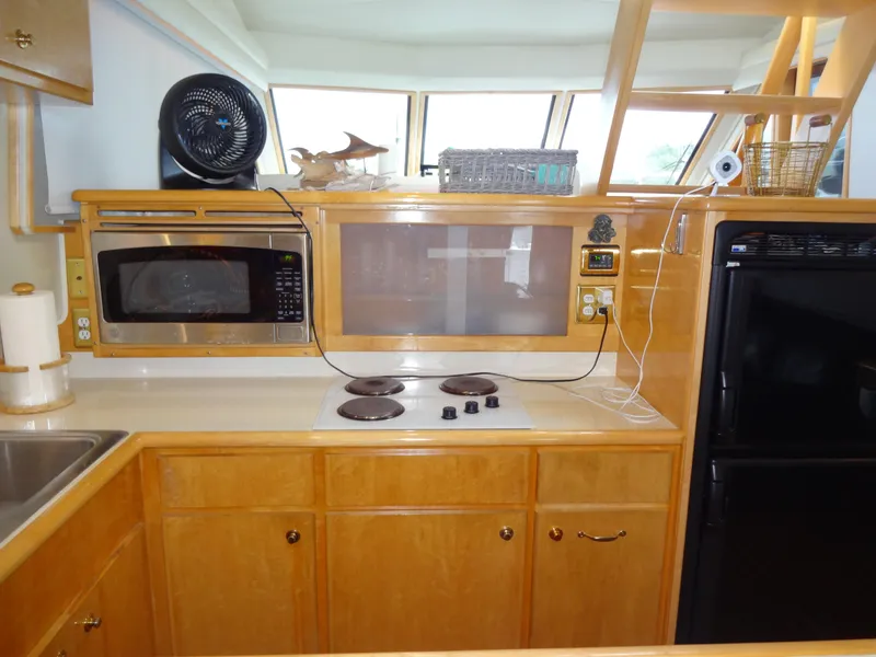 Slide: The Image of Kitchen area of 1998 Navigator 53 Classic yacht with stove, microwave, and cabinets. - 21