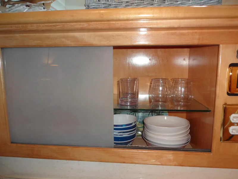 Slide: The Image of Wooden cabinet with glassware and dishes on a Navigator 53 Classic, 1998 model. - 22