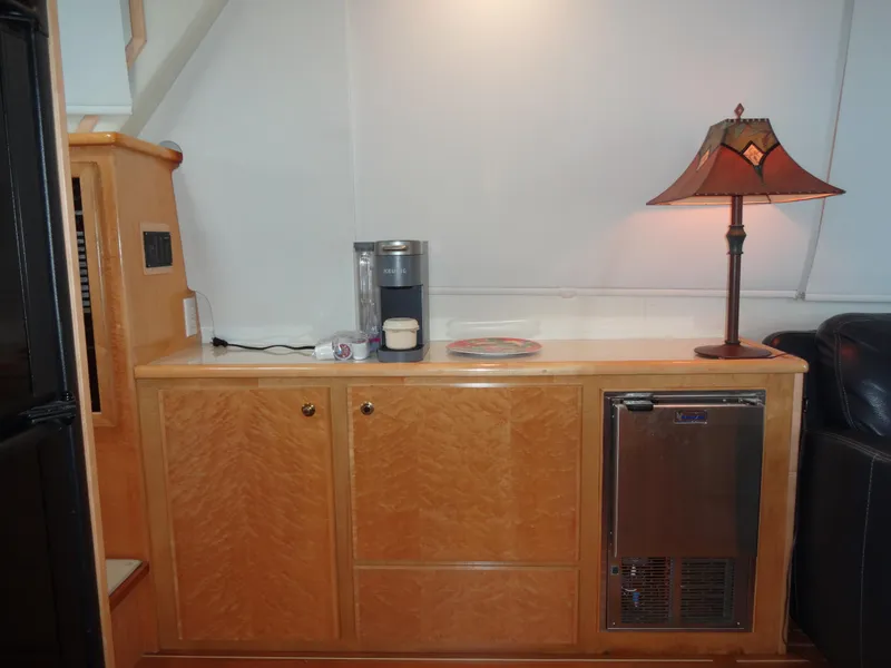 Slide: The Image of 1998 Navigator 53 Classic yacht interior with wooden cabinetry, lamp, and Keurig coffee maker. - 24
